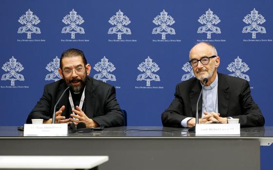 Bishop Daniel Flores of Brownsville, Texas, speaks during a briefing about the assembly of the Synod of Bishops as Cardinal Michael Czerny, prefect of the Dicastery for Promoting Integral Human Development, listens at the Vatican Oct. 19. (CNS/Lola Gomez)